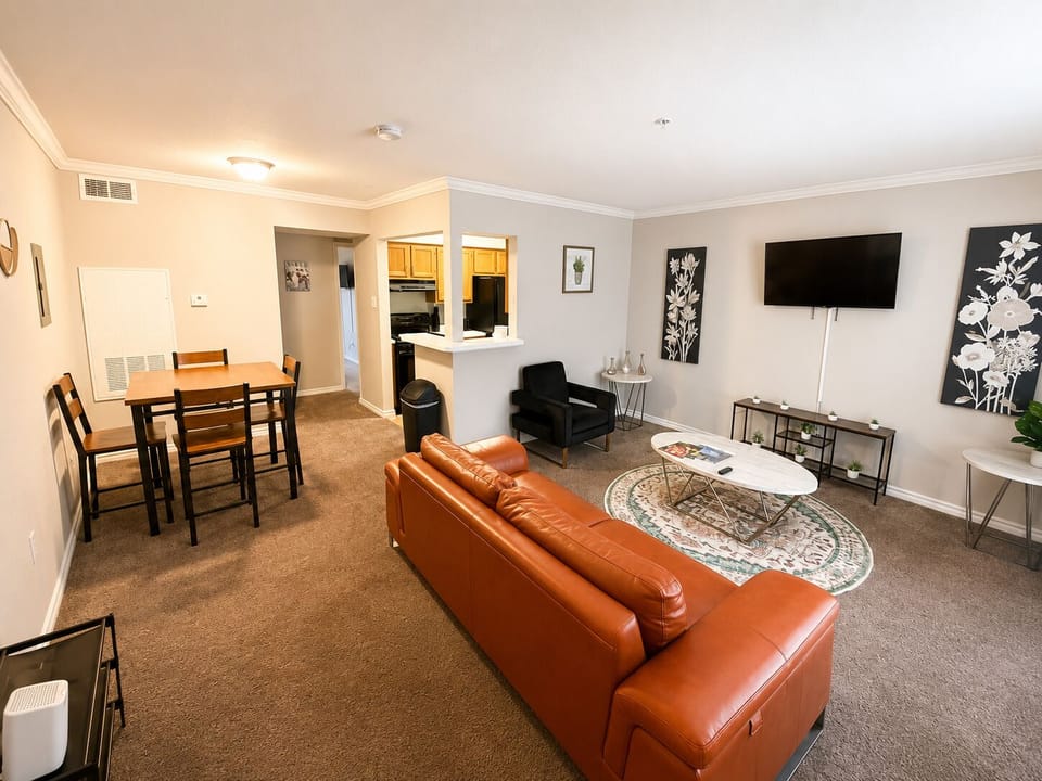 Bright open living space with dining area, TV, and cozy seating