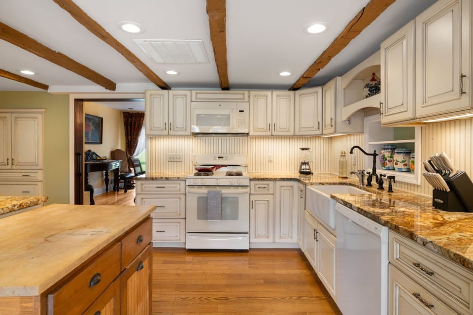 Spacious farmhouse kitchen with full prep space and island seating