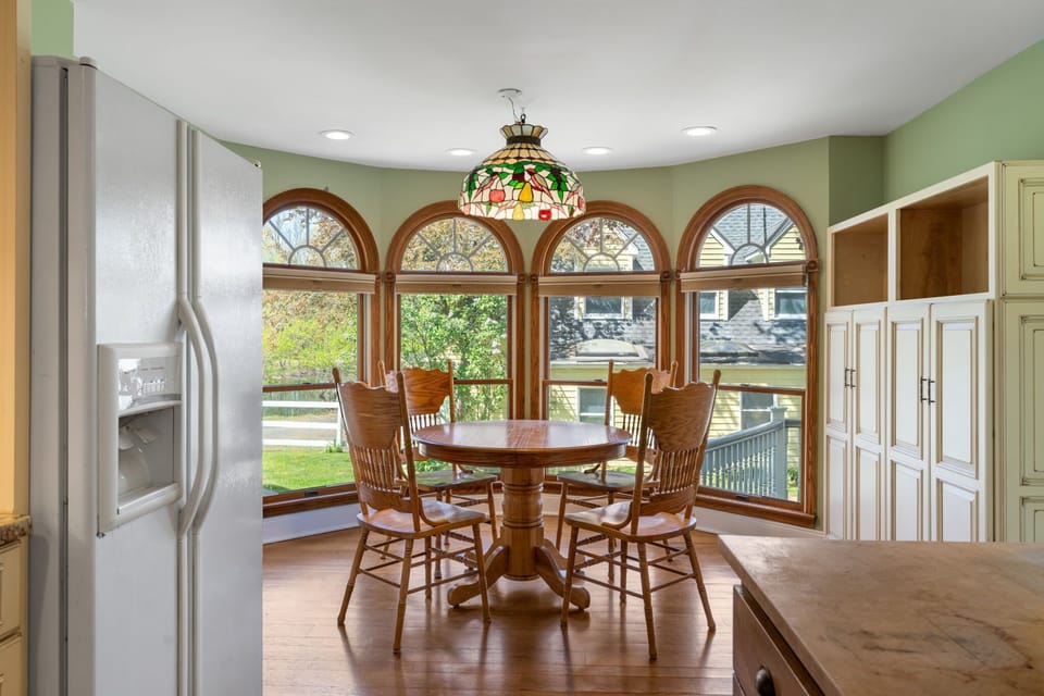 Bright breakfast nook surrounded by natural light and garden views