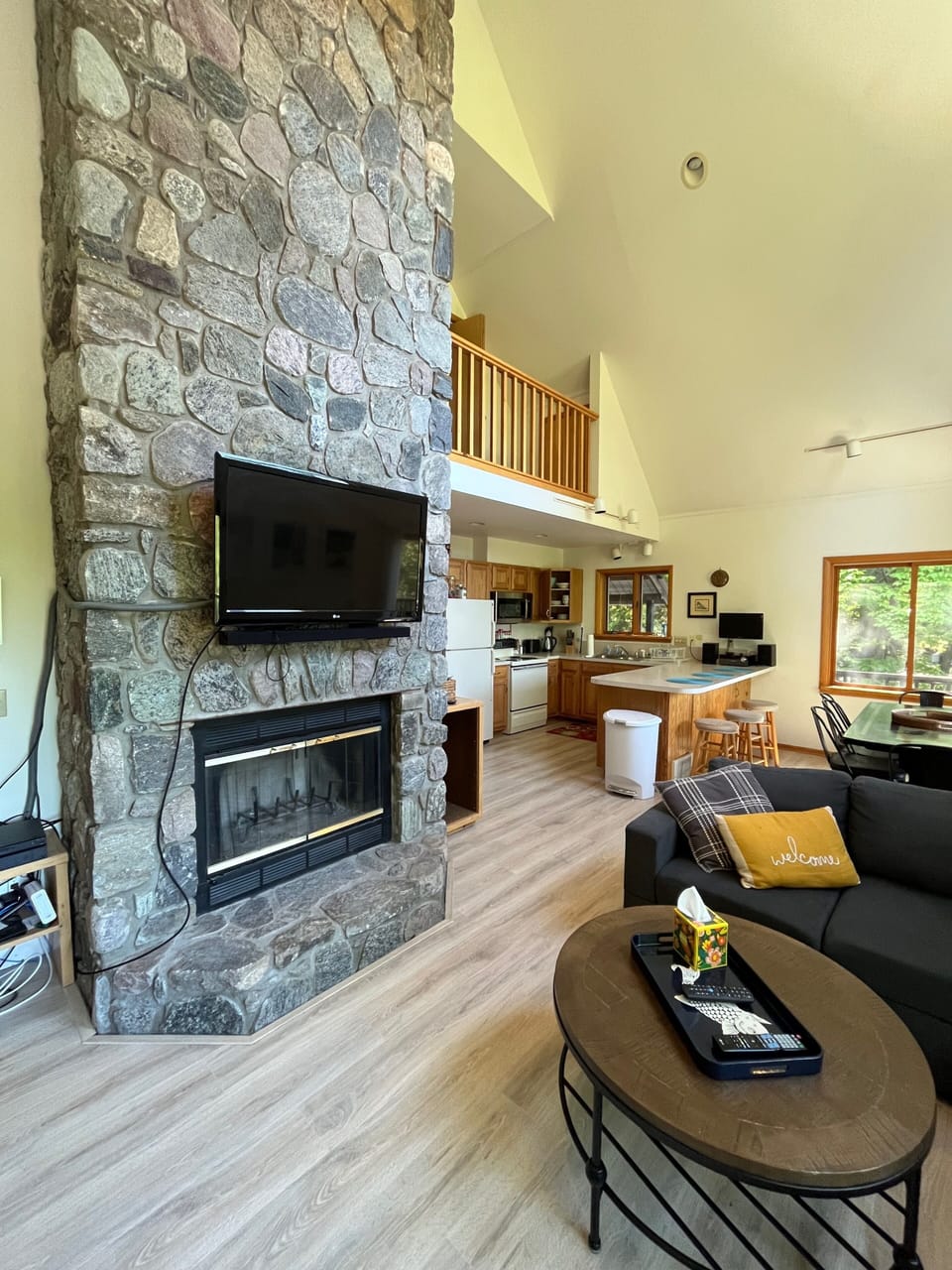 Stone fireplace anchors the living space.