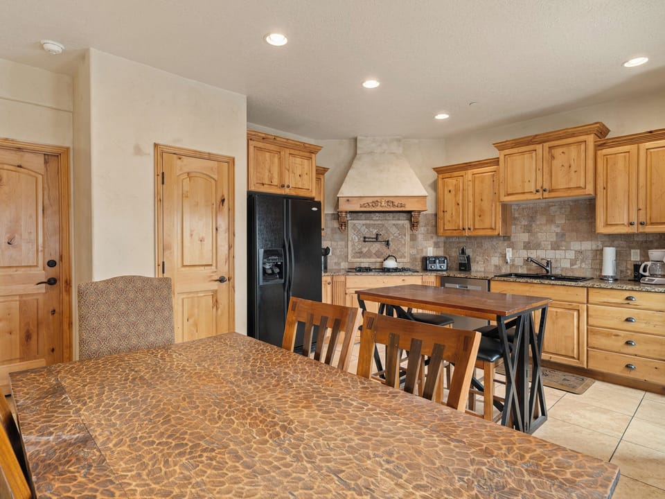 A fully equipped kitchen showcasing timeless materials and ample storage, ideal for both casual meals and gourmet preparation.