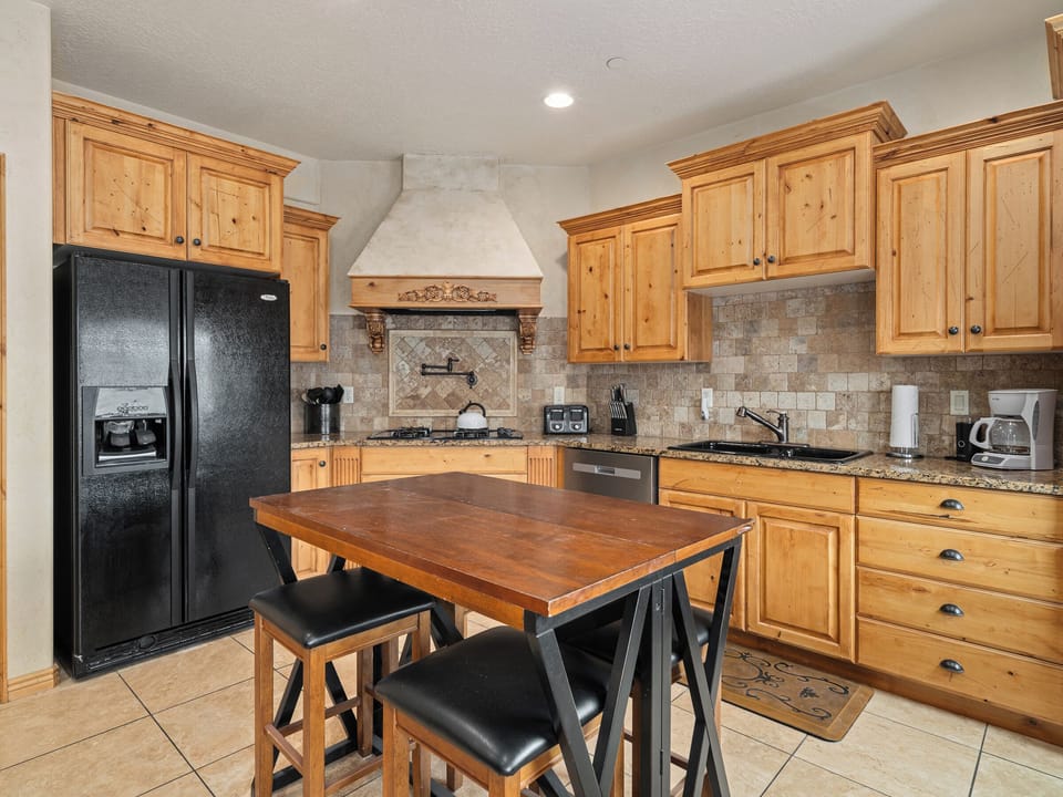 A thoughtfully designed kitchen and dining area featuring rich wood cabinetry, generous workspace, and an inviting layout for effortless entertaining.