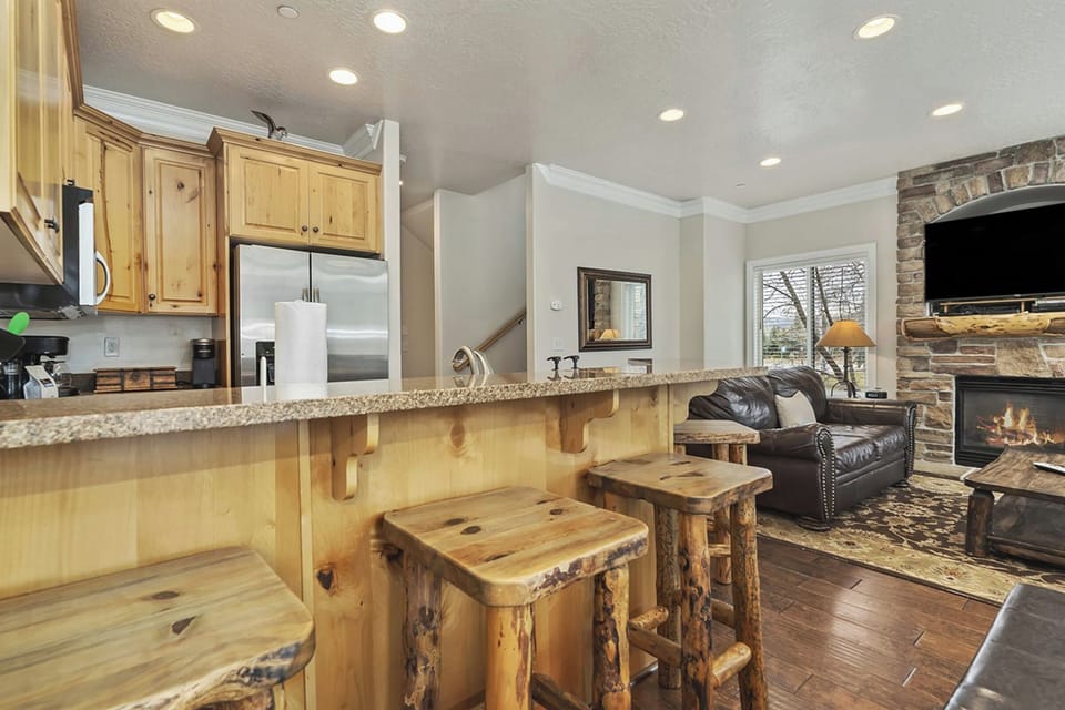 A breakfast bar with additional seating provides a casual dining option while keeping everyone connected to the main living space.