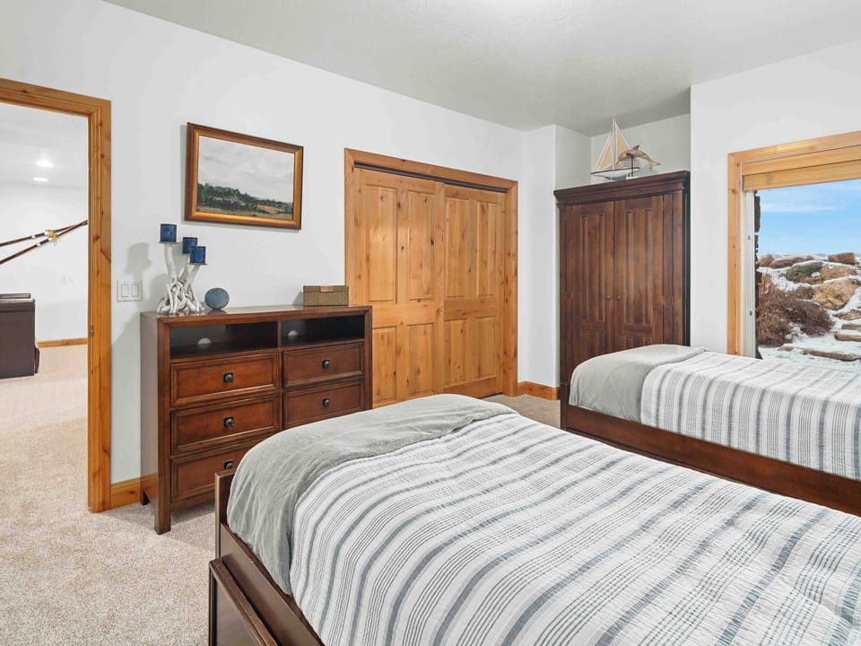 Bright bedroom with comfortable bedding and ample storage.