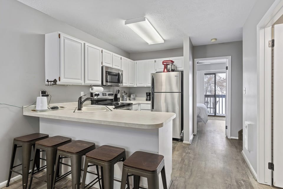 Fully equipped kitchen with breakfast bar—everything you need for home-cooked meals.