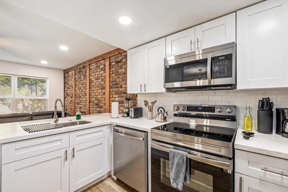 A cozy, fully stocked kitchen with everything you need—complete with modern appliances and a dishwasher.