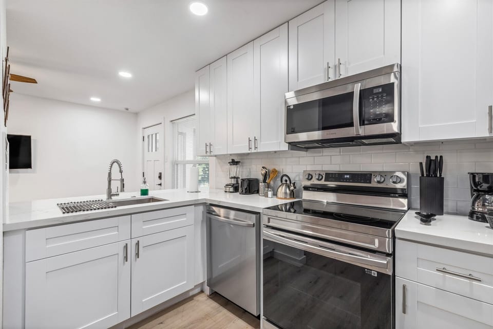 This kitchen is fully equipped with everything you need, including a dishwasher to make cleanup a breeze.