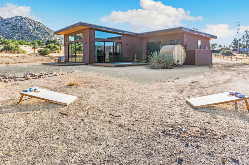 Modern desert retreat with mountain views and outdoor cornhole fun