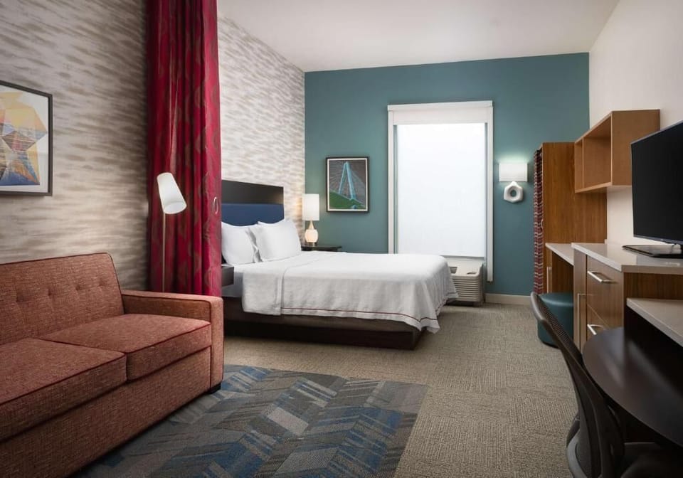 Settle in with a comfy bed and productive work zone.