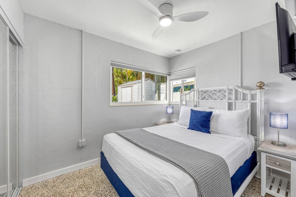 Comfortable bedroom retreat with charming details and window views.