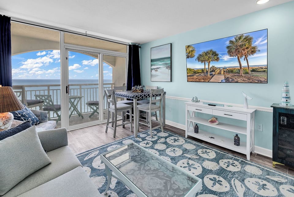 Beautiful oceanfront view from your penthouse suite! Comfortable living room with a 65" Roku TV, doubles as a second sleeping area with a pull out sofa sleeper! Also has a dining room table and chairs!