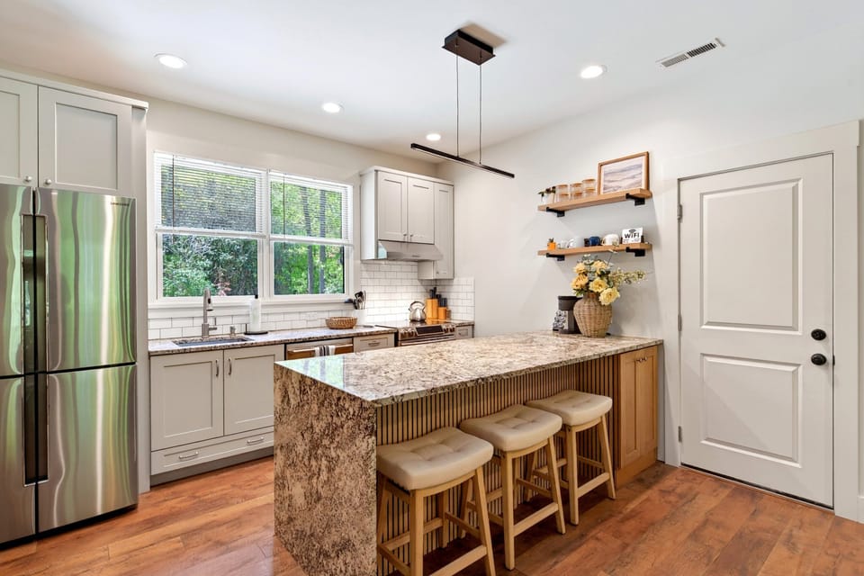 Main kitchen with island seating for 3, dishwasher, drip-style coffee maker, and Keurig coffee maker