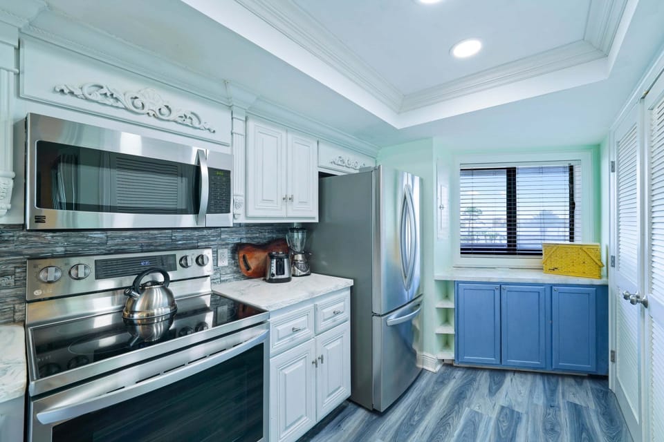 Prepare your favorite meals in this updated beachfront condo kitchen featuring stainless steel appliances, modern finishes, and plenty of counter space.