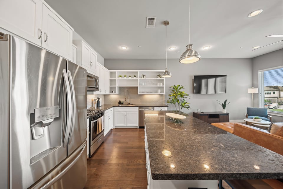 Bright open kitchen with granite island and stylish modern living space