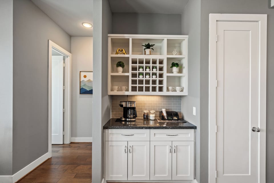 Chic built-in coffee bar with wine storage and elegant modern finishes