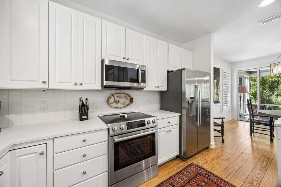 Updated Kitchen with Quartz Countertops, Stainless Steel Appliances, and Barstool Seating for 2