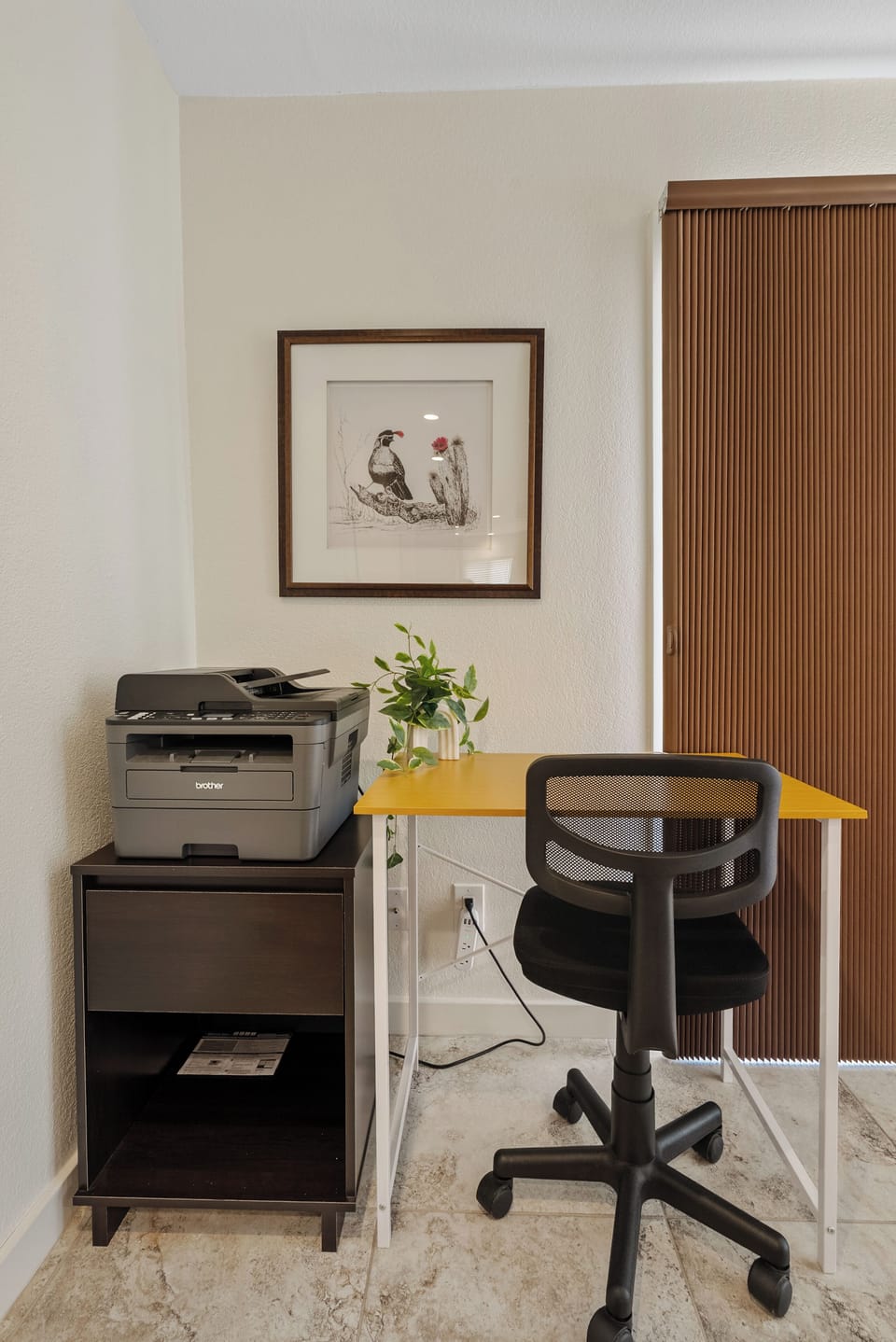 Dedicated workspace with desk, chair, and printer, perfect for remote work or extended stays.