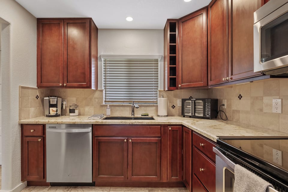 Modern kitchen with granite countertops, stainless steel appliances, and plenty of space for cooking and prep.