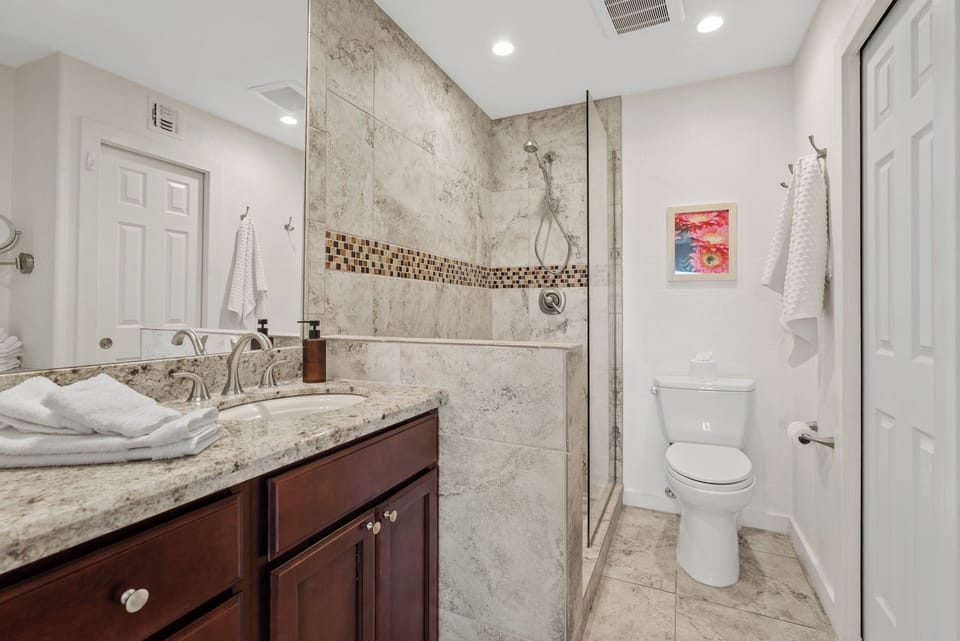 Primary ensuite bathroom with walk-in shower, updated finishes, and a clean, modern feel.
