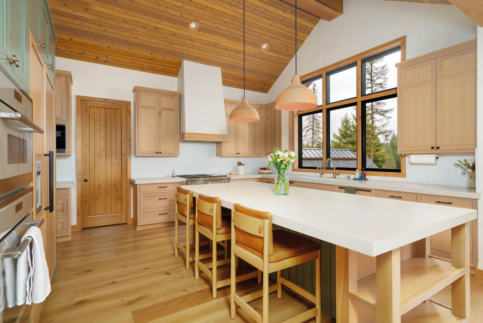 Kitchen island with breakfast bar seating for four — the ideal spot for morning pancakes, wine hour, or homework while dinner is cooking.
