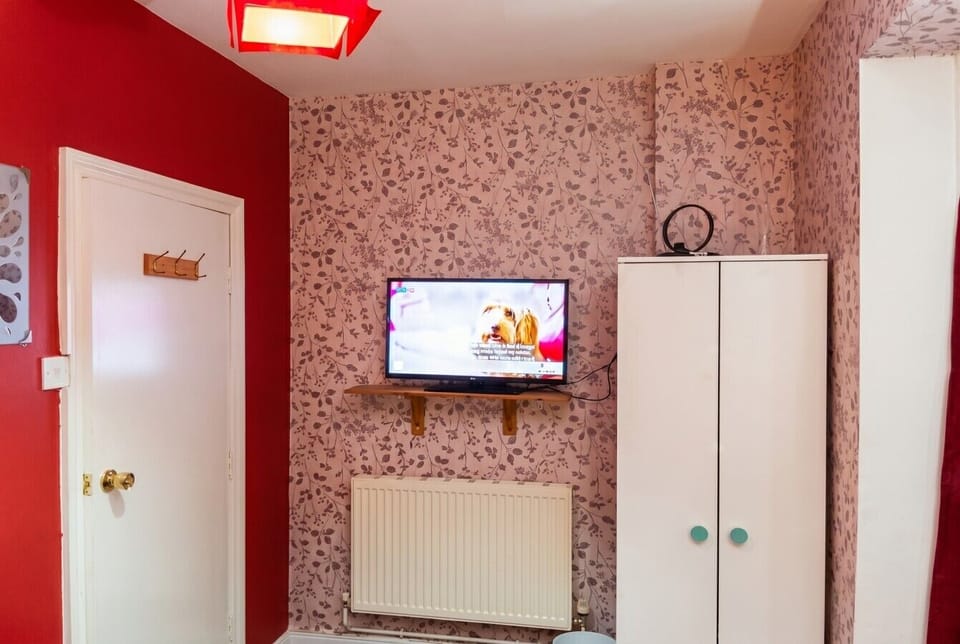 Each bedroom has its own TV and wardrobe for a comfortable private stay.