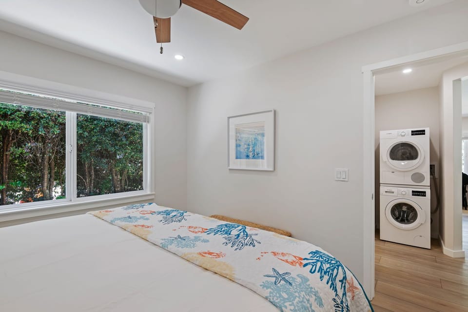 Rest peacefully in this bright bedroom with garden views and convenient in-suite laundry facilities for ultimate comfort.