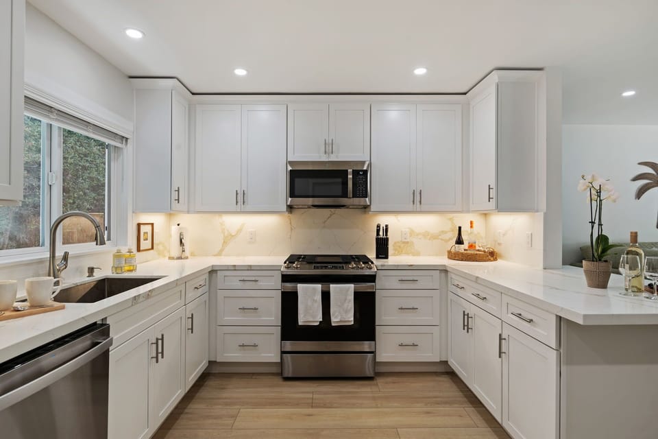 Your spacious kitchen awaits with gleaming quartz counters, premium appliances, and warm under-cabinet lighting for memorable home-cooked meals together.