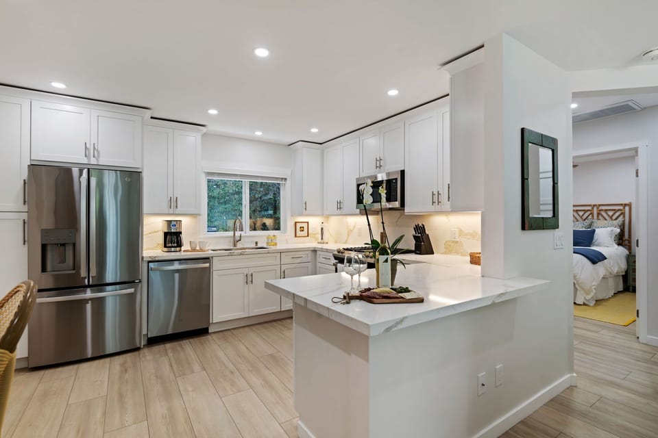 Your modern kitchen awaits with gleaming appliances, quartz countertops, and everything you need to create memorable meals during your stay.