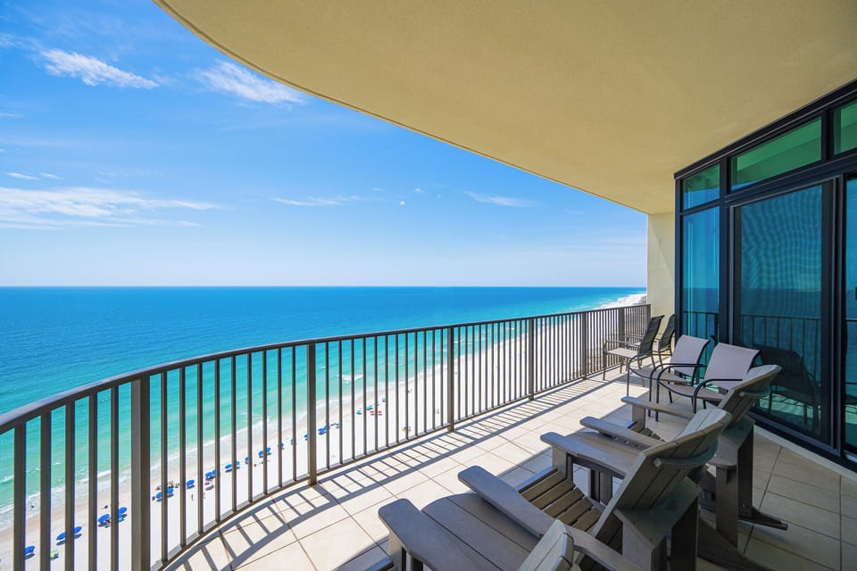 Relax in your cozy chairs on the balcony, taking in the stunning coastline and vibrant beach activities below
