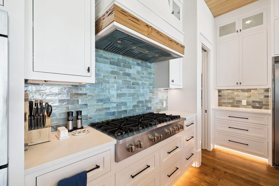 Your fully-equipped kitchen awaits with professional-grade appliances and beautiful tile backsplash for memorable cooking experiences.