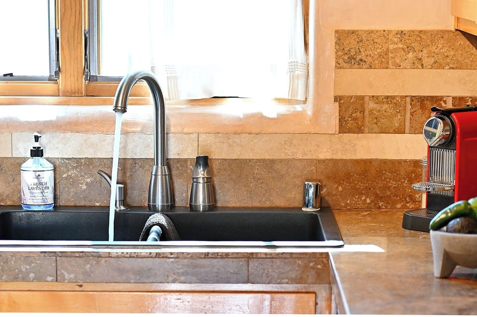 Prepare fresh meals in your fully equipped kitchen featuring granite counters, modern fixtures, and premium appliances.
