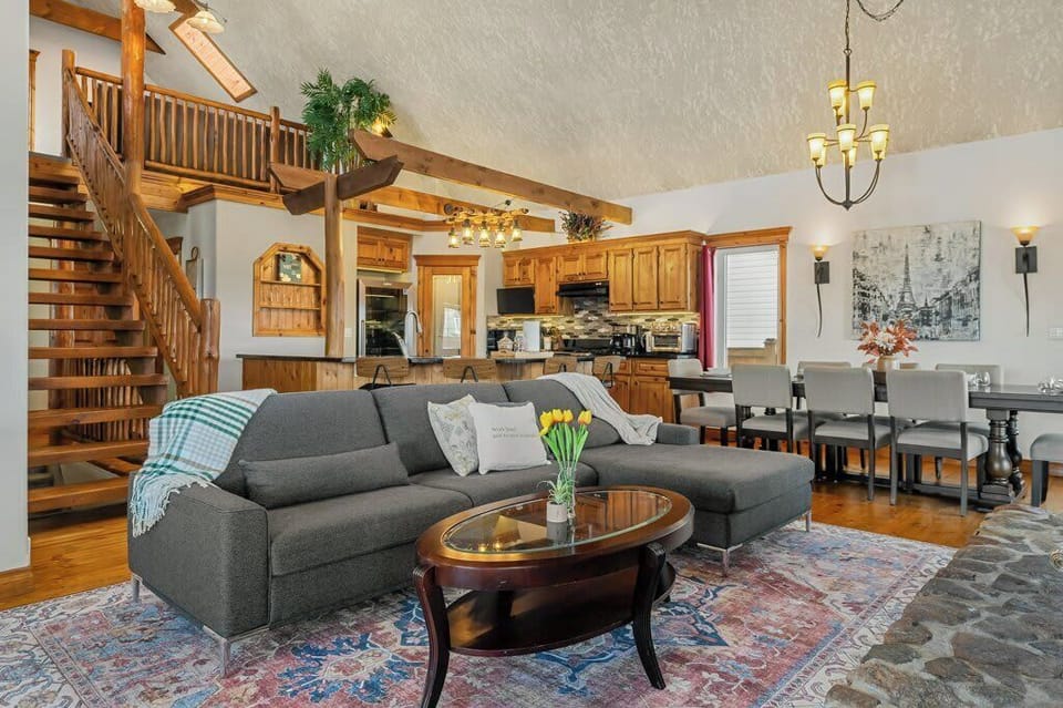 Warm living room with stunning floor to ceiling stone fireplace