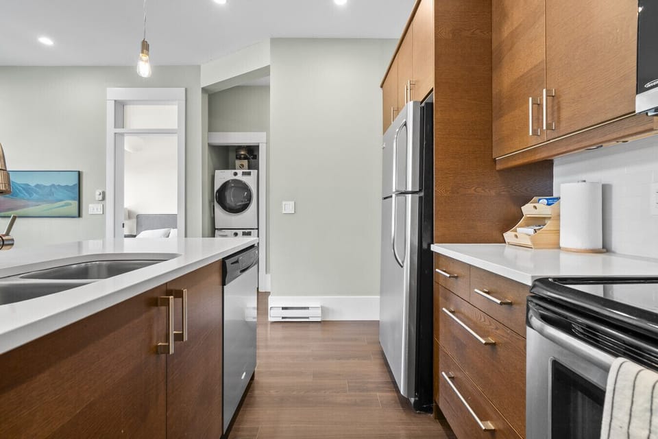Kitchen: Experience culinary creativity in this sleek, modern kitchen with elegant finishes and ample space!
