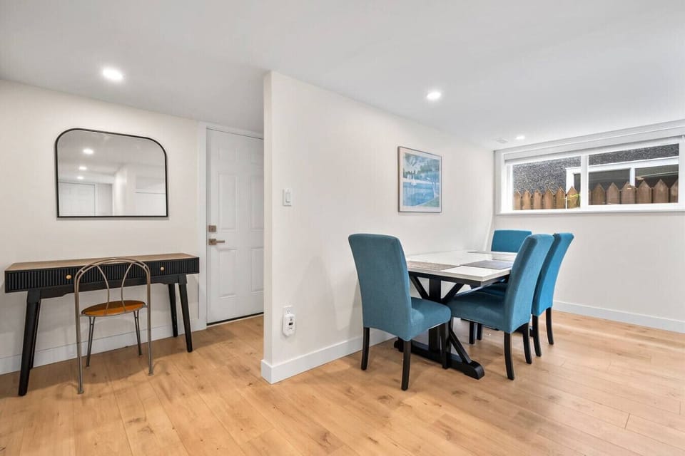 Dining area with seating for four and a small workspace.