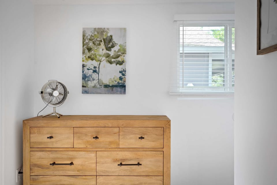 Every bedroom is a sanctuary — featuring warm natural wood furnishings, curated artwork, and soft natural light for the most restful nights away from home. 