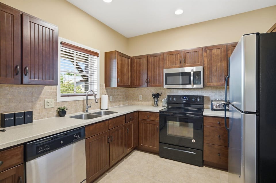 Cook, snack, or gather with your group in this fully equipped kitchen, stocked with everything you need and open to the main living space for easy connection.