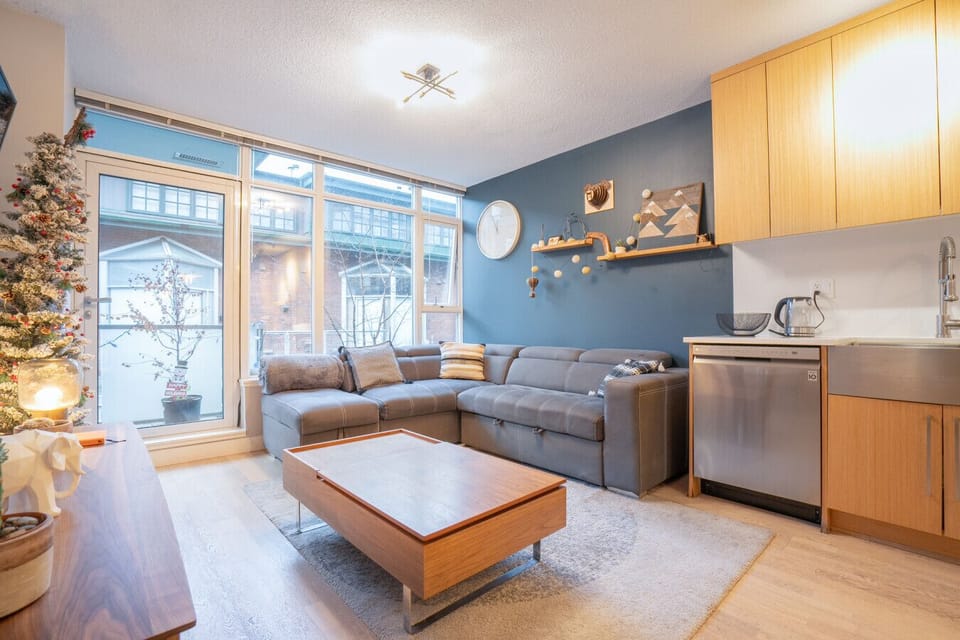 Living Room: Bright space with a sectional sofa, modern decor, and easy outdoor access!