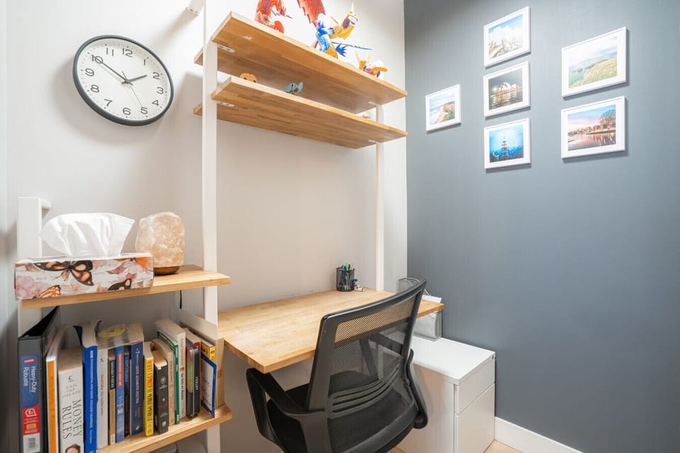 Workspace Haven: Bright desk area with stylish shelving and inspiring wall art for productivity!
