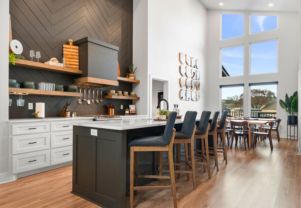 The kitchen makes a statement with its oversized island, sleek finishes, and plenty of prep space, making it just as functional as it is beautiful.