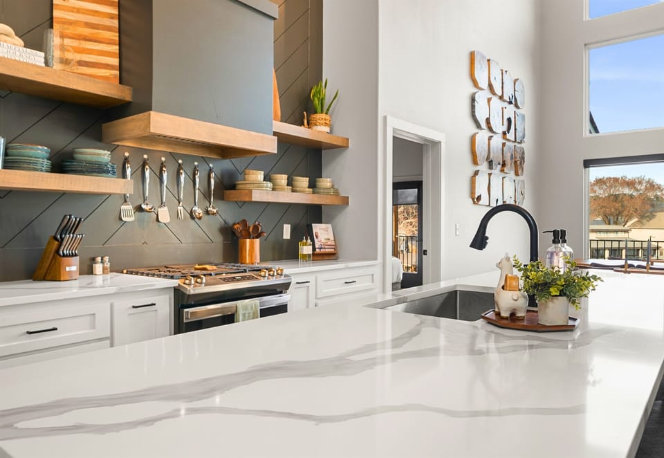 The bright and airy kitchen features high-end appliances, generous counter space, and an open design that keeps everyone connected.
