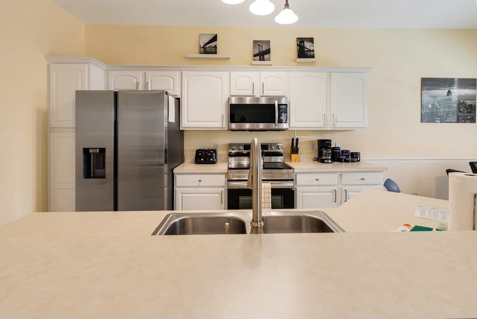 Modern kitchen with stainless steel appliances and a spacious countertop island.
