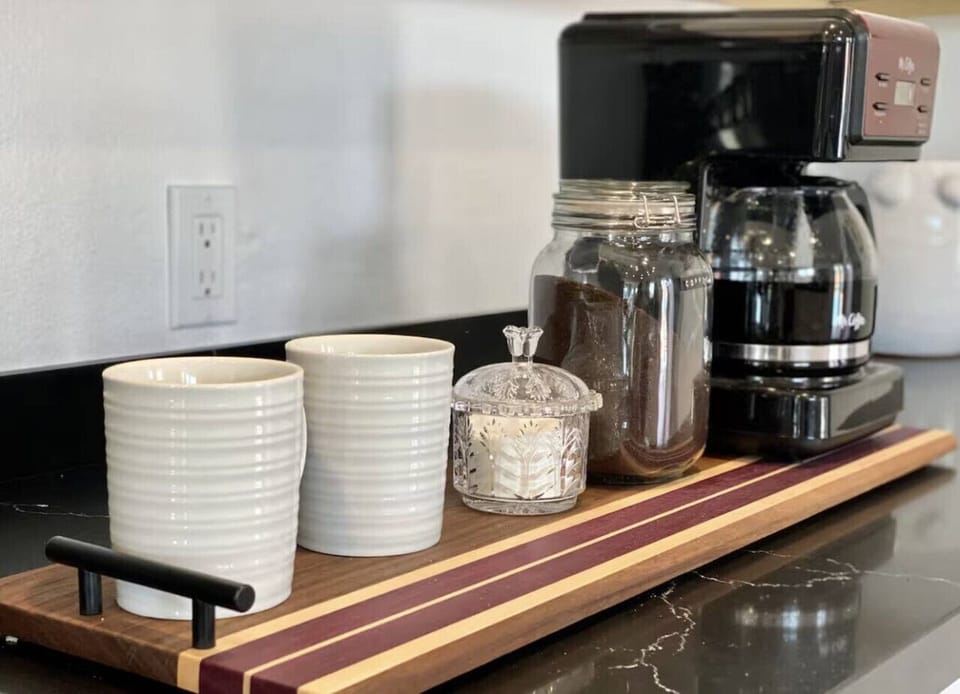 A dedicated coffee station with a drip coffee maker, ground coffee, and everything you need to start your morning right.