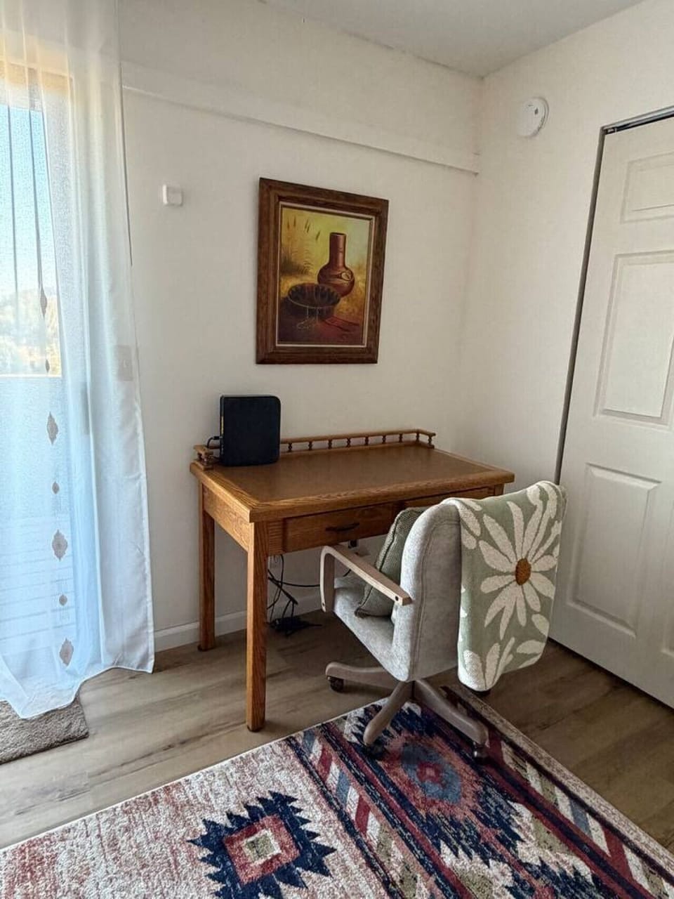 Dedicated workspace In the primary bedroom complete with a desk and chair