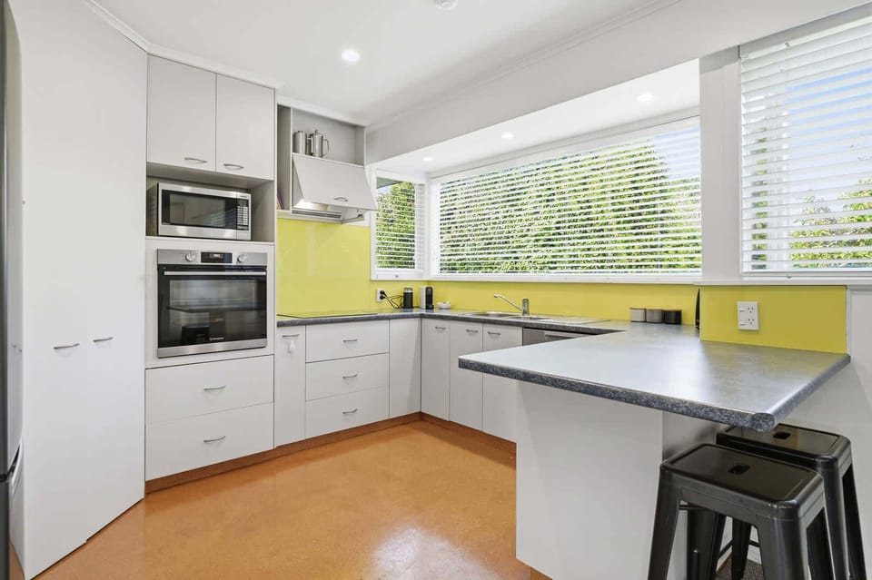 Kitchen with yellow splashback