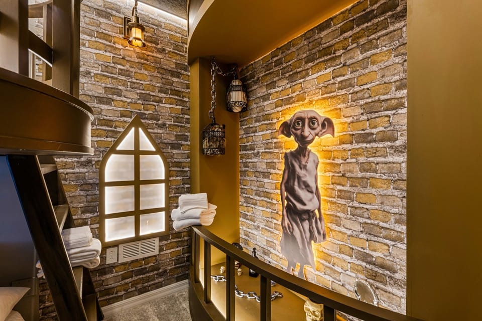 Magical details galore-glowing brick walls, lanterns, and a friendly house-elf mural-right by the twin-over-full bunks for storytime dreams.
