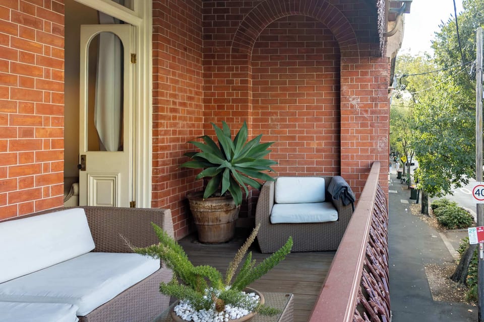 Main bedroom with a private balcony and comfortable seating, offering a peaceful spot to relax and enjoy the fresh air.