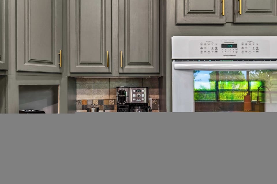 A fully stocked kitchen with top-tier appliances and plenty of cabinet space to store all your essentials. Start your mornings perfectly with the dedicated coffee station, featuring a modern brewer and everything you need for a fresh cup. 
