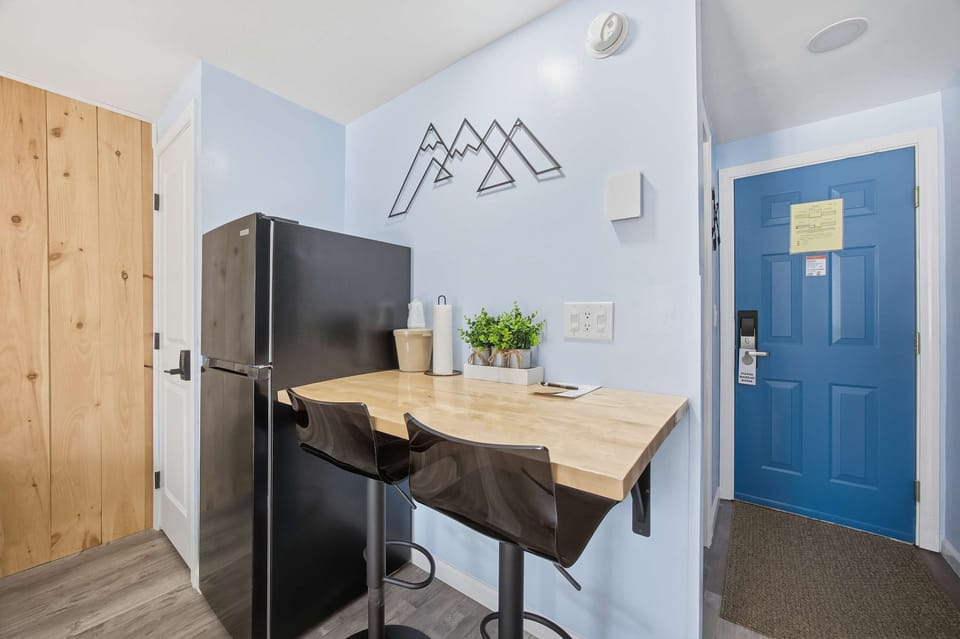 Recharge in this inviting suite, featuring a king bed, dining area, & TV​