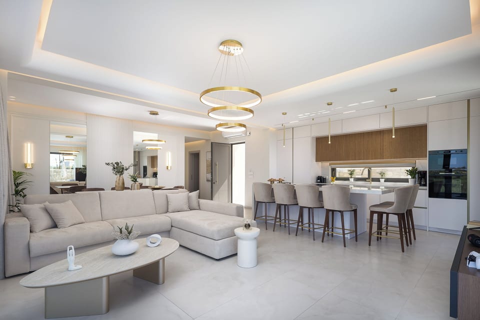 The living room is thoughtfully designed for relaxation and entertainment, featuring a 55” TV, a JBL Bluetooth speaker, a PlayStation 5, and a sofa that can be converted into a comfortable double bed for two additional guests.