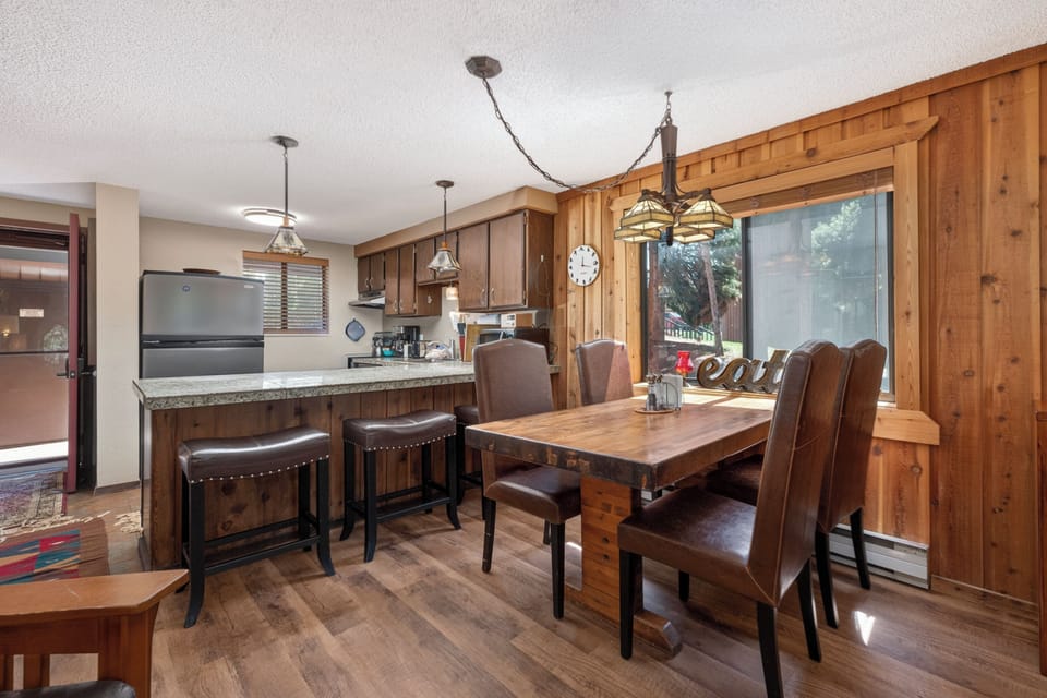 Your rustic kitchen and dining area features warm wood details, granite counters, and mountain lodge charm for memorable meals.